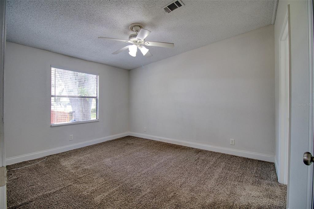 6804 Stafford Road Plant City, FL 33565 - Photo 8 of 24 an empty room with windows and fan