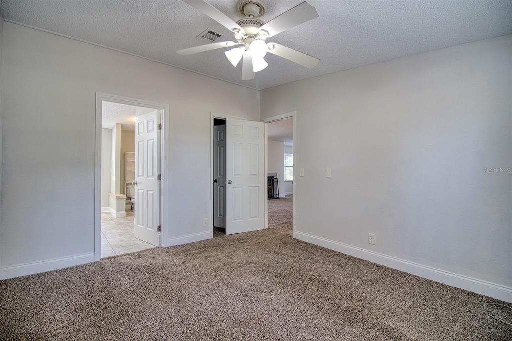 6804 Stafford Road Plant City, FL 33565 - Photo 9 of 24 an empty room with closet and a ceiling fan