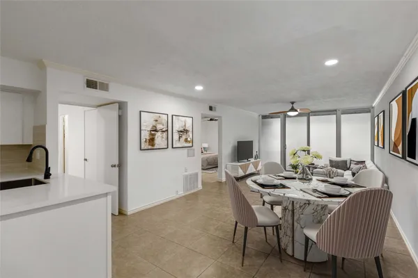a dining room with furniture and window