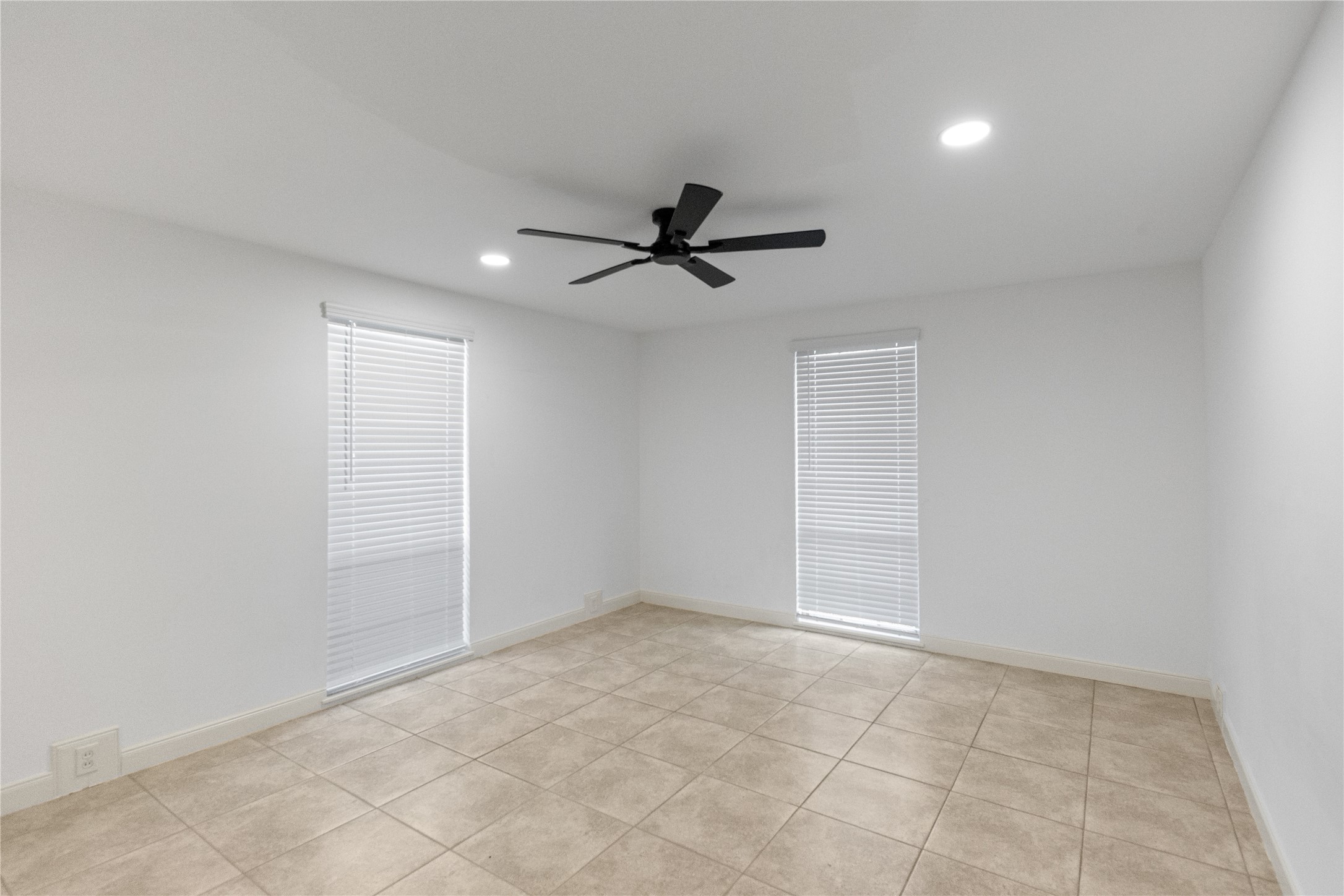 5353 Institute Lane, Unit 12 Houston, TX 77005 - Photo 11 of 15 an empty room with chandelier fan and windows