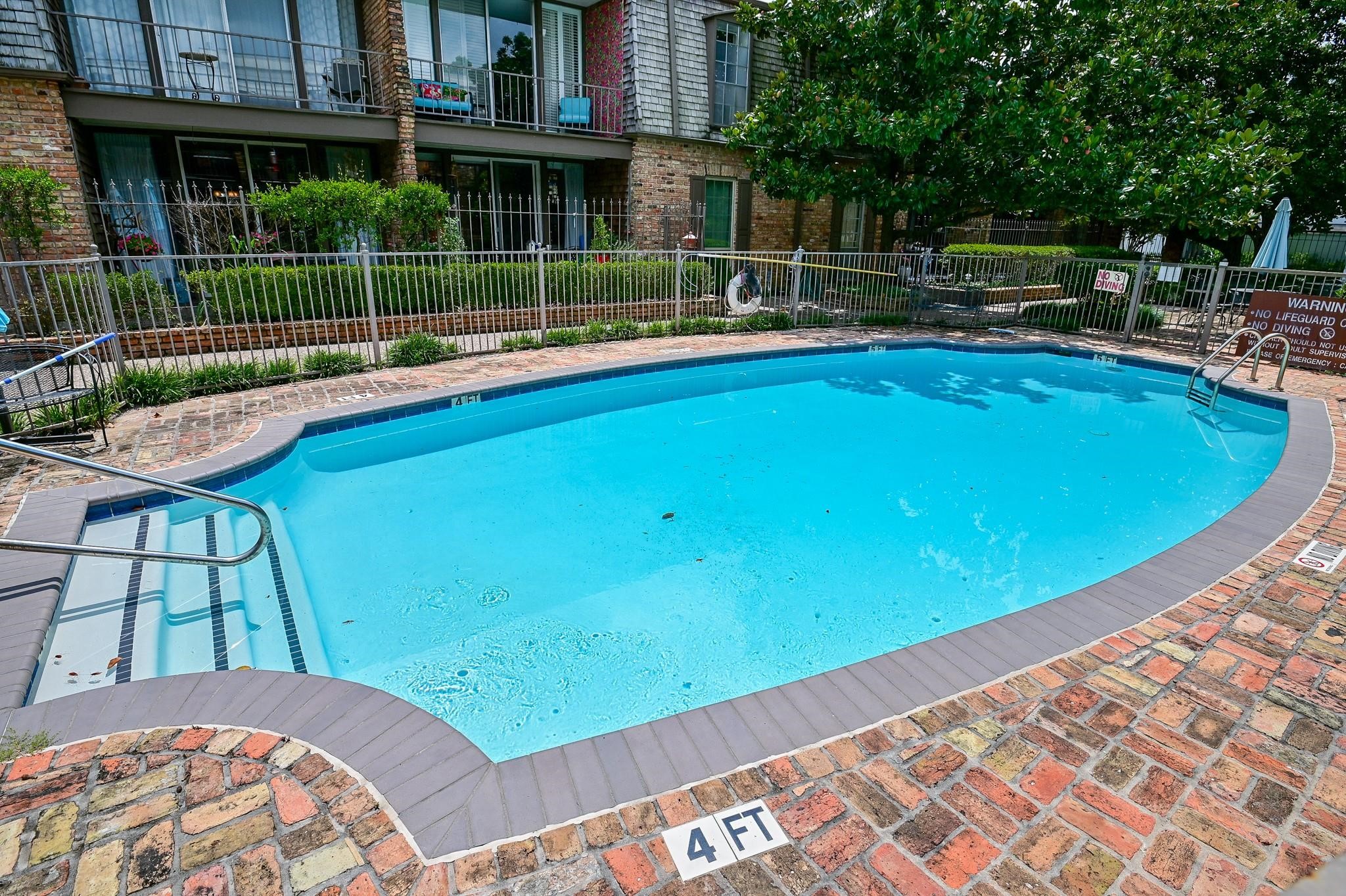 5353 Institute Lane, Unit 12 Houston, TX 77005 - Photo 13 of 15 a view of a swimming pool with a patio and a garden