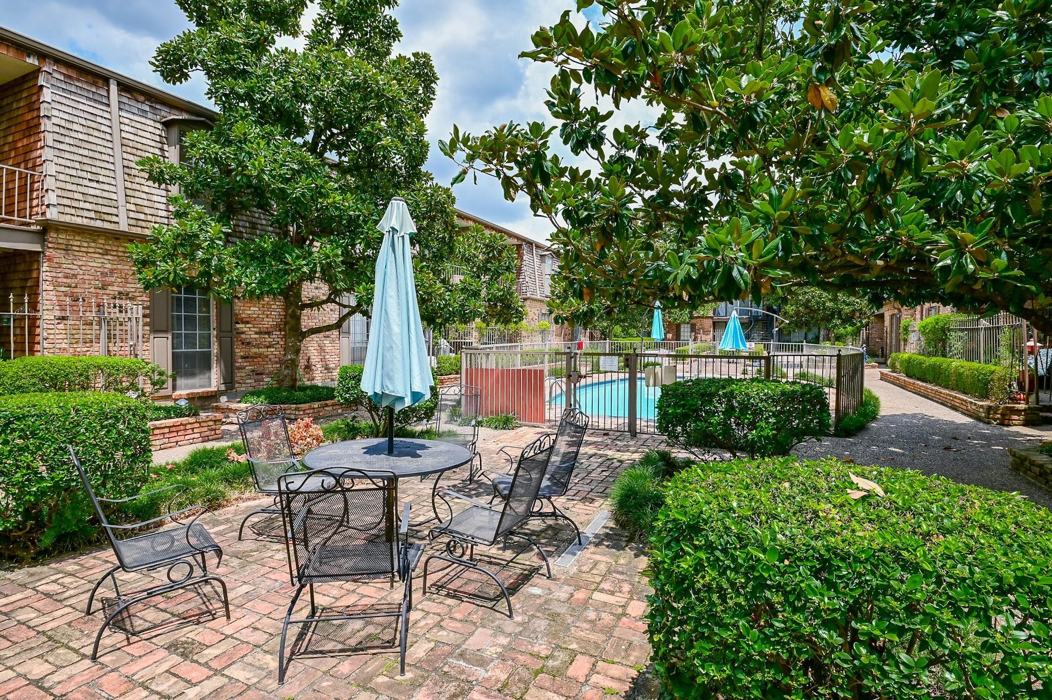 5353 Institute Lane, Unit 12 Houston, TX 77005 - Photo 14 of 15 a view of a chair and table in backyard of the house