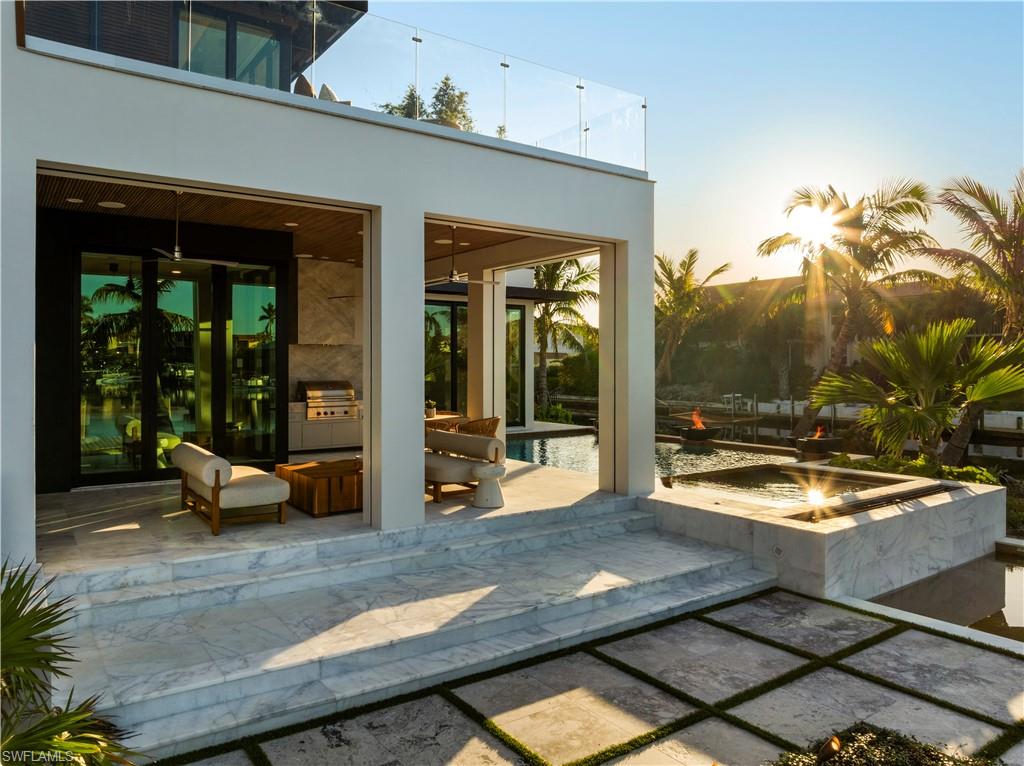 1100 Sandpiper Street Naples, FL 34102 - Photo 12 of 47 a view of a patio with chair and tables