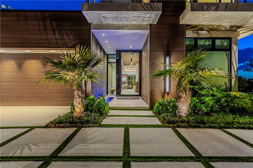 1100 Sandpiper Street Naples, FL 34102 - Photo 16 of 47 a front view of a house with garden