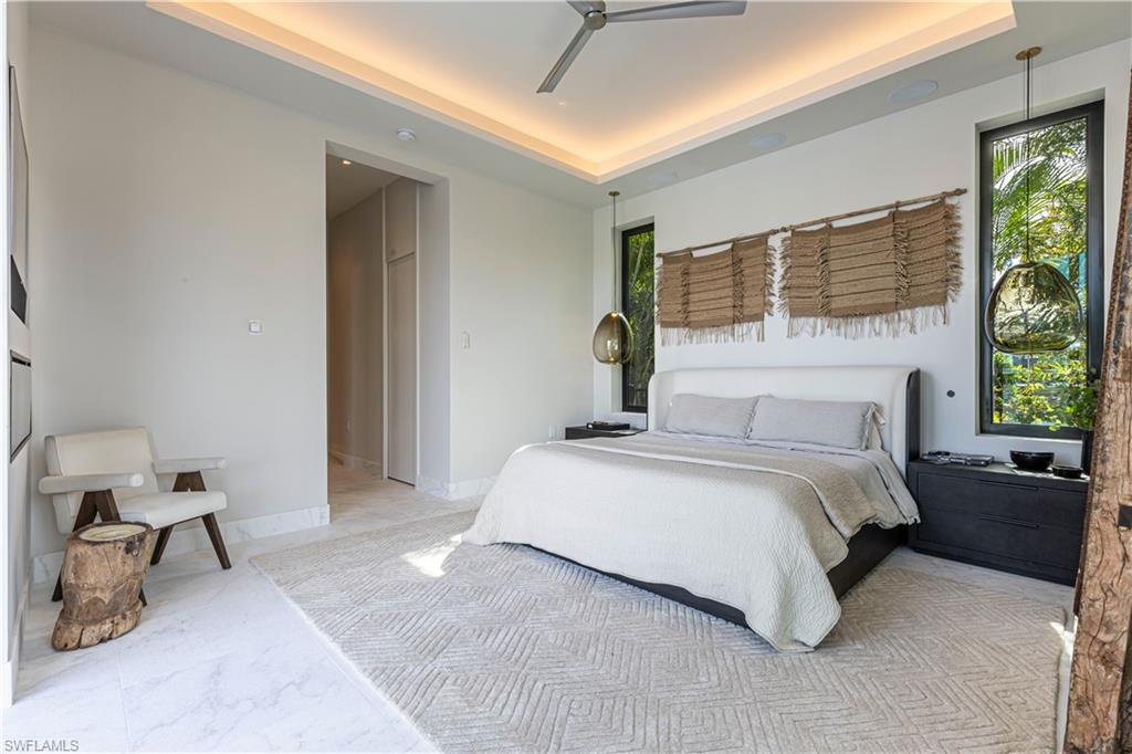 1100 Sandpiper Street Naples, FL 34102 - Photo 23 of 47 a bedroom with bed and a large window