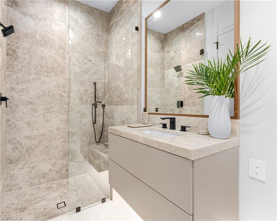 1100 Sandpiper Street Naples, FL 34102 - Photo 28 of 47 a bathroom with a granite countertop sink a mirror and a shower