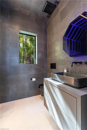 a bathroom with a granite countertop sink a toilet and shower