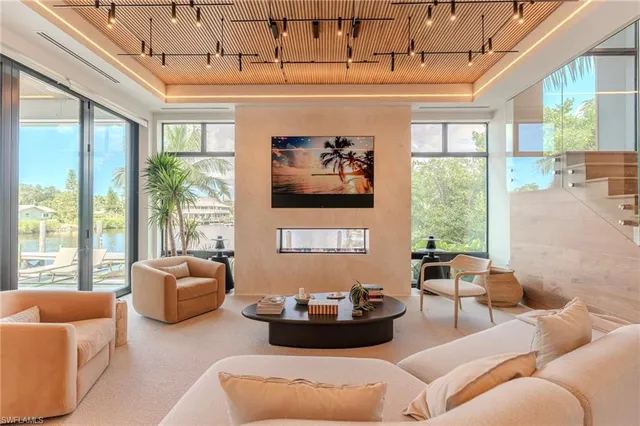 a dining hall with stainless steel appliances kitchen island granite countertop a living room view