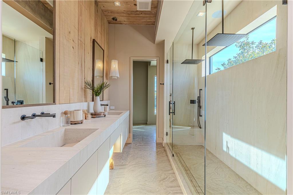 1100 Sandpiper Street Naples, FL 34102 - Photo 34 of 47 a bathroom with a double vanity sink and mirror