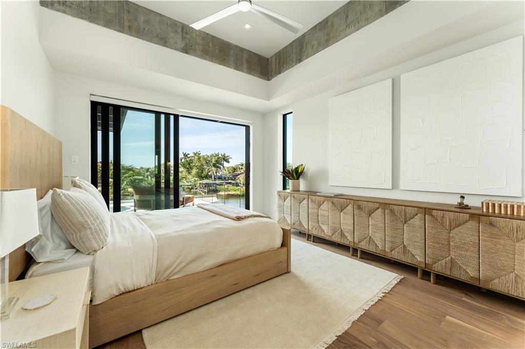 1100 Sandpiper Street Naples, FL 34102 - Photo 37 of 47 a bedroom with a large bed and a large window