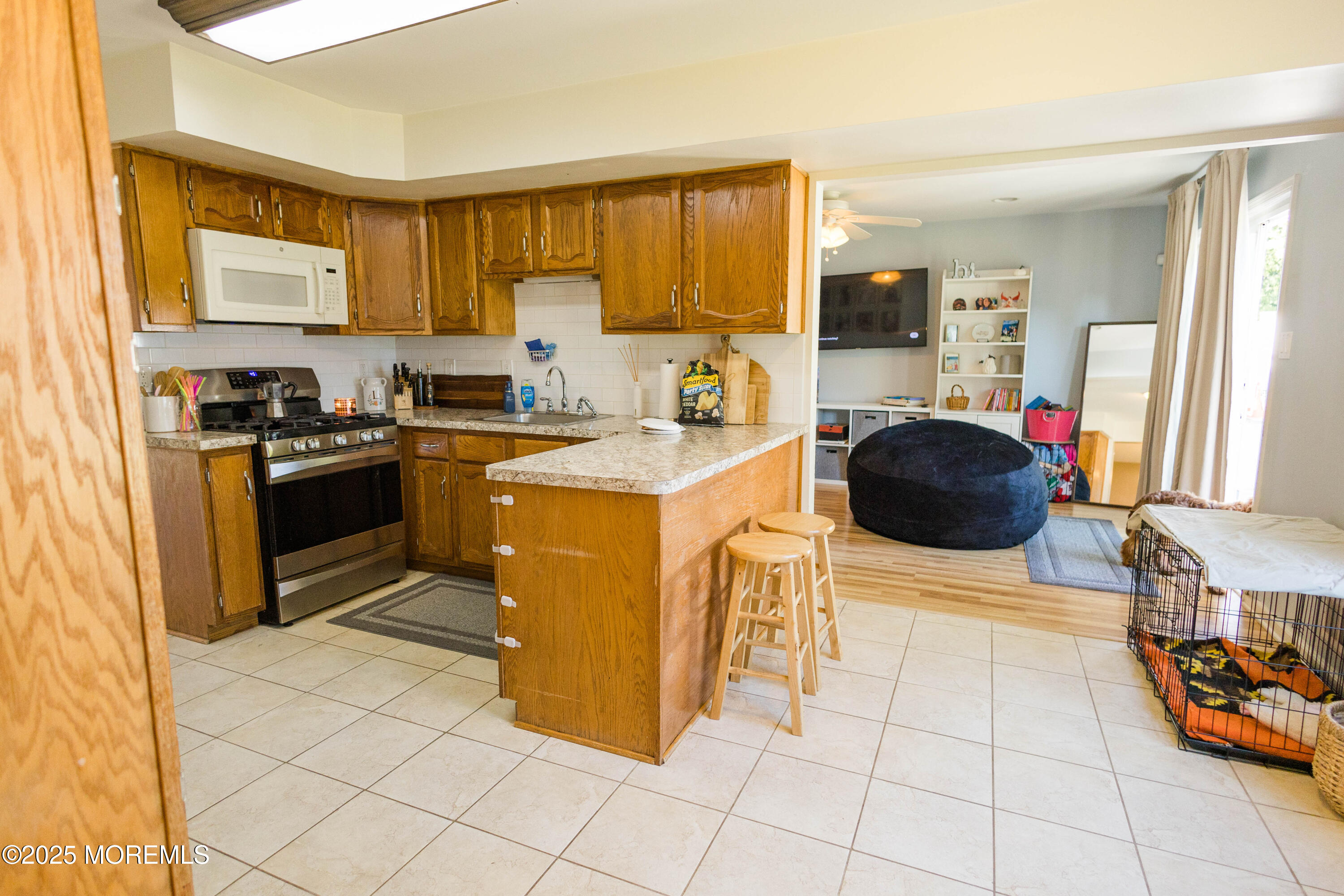29 Snowdrift Lane Howell, NJ 07731 - Photo 8 of 32 a kitchen with stainless steel appliances a stove a sink a microwave a counter top space and cabinets