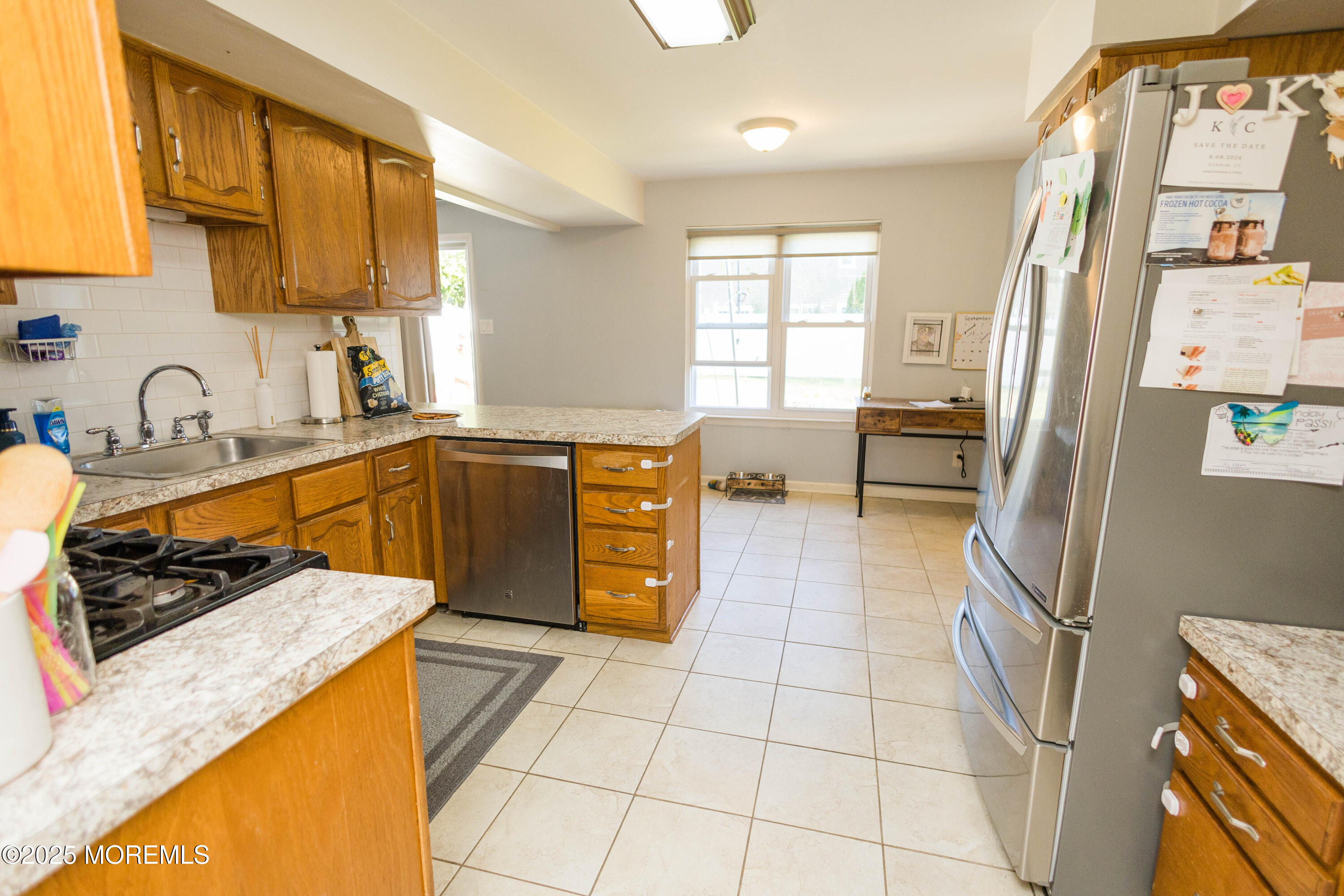 29 Snowdrift Lane Howell, NJ 07731 - Photo 9 of 32 a kitchen with stainless steel appliances granite countertop a sink stove and refrigerator