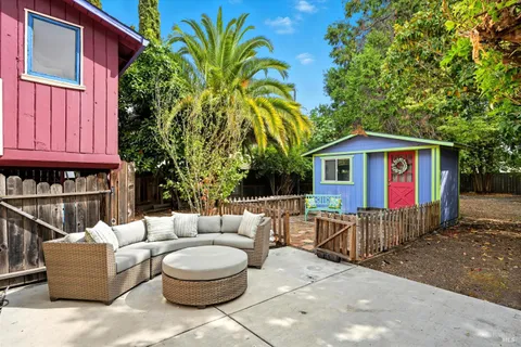 a view of patio with a couch and potted plants