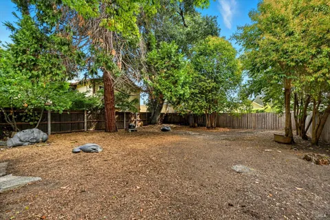 a backyard of a house with table and chairs
