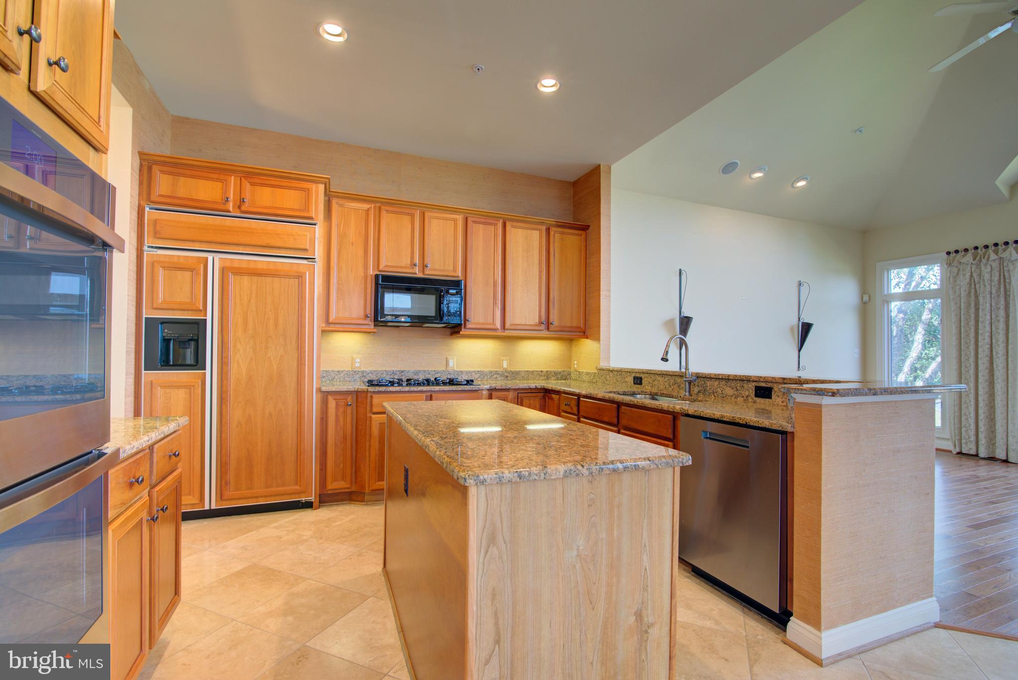 43462 Firestone Place Leesburg, VA 20176 - Photo 17 of 80 a kitchen with stainless steel appliances granite countertop a stove a sink and a refrigerator
