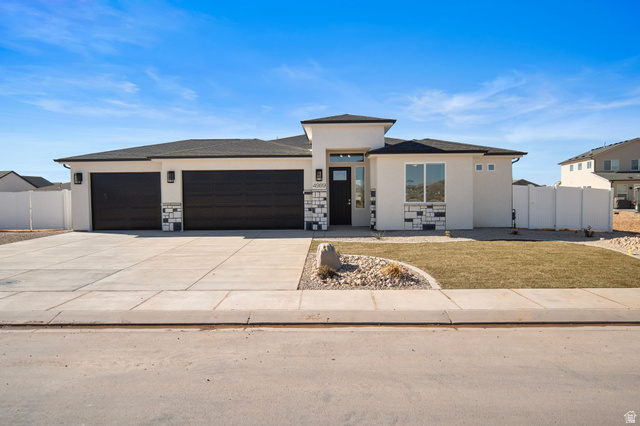 4989 North Remington Road Enoch, UT 84721 - Photo 1 of 1 Home with stucco siding, concrete driveway, an attached garage, and stone siding