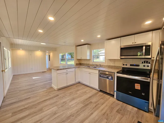 a kitchen with a stove top oven and cabinets
