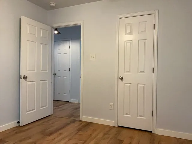 an empty room with wooden floor