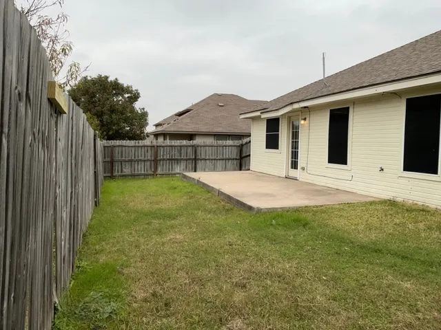 a view of a backyard with a garden and plants