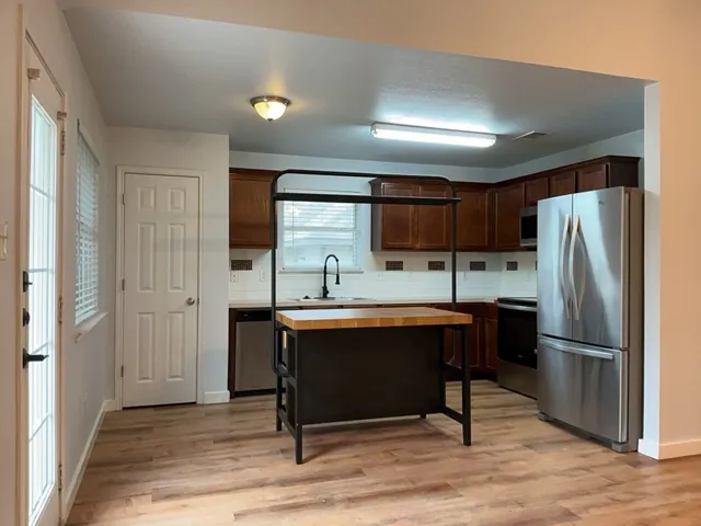 a kitchen with stainless steel appliances a refrigerator and a sink
