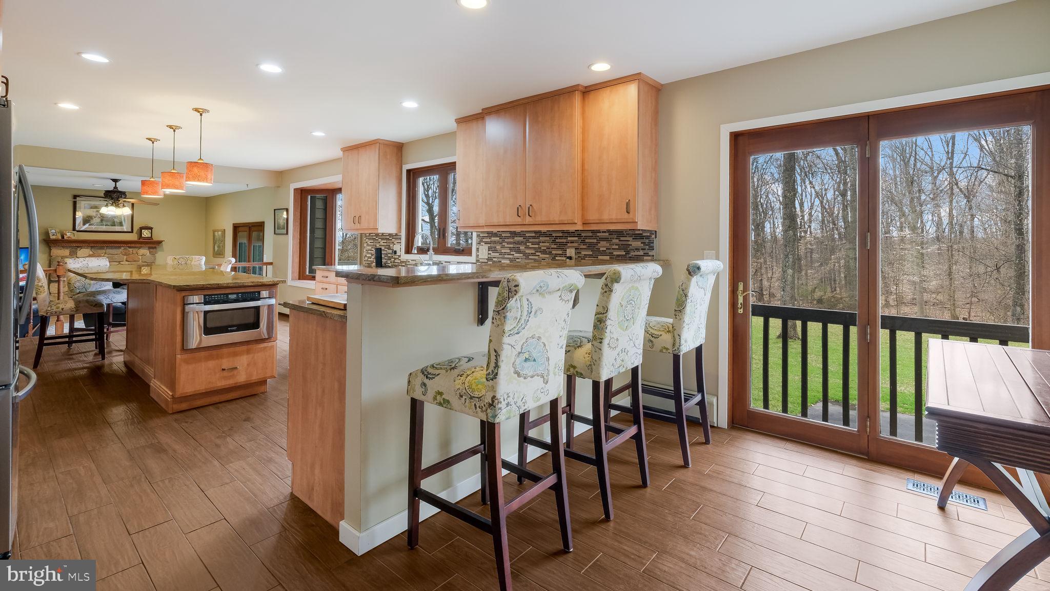 35 Declaration Drive Newtown, PA 18940 - Photo 16 of 53 a kitchen with stainless steel appliances granite countertop dining table chairs sink and wooden floor