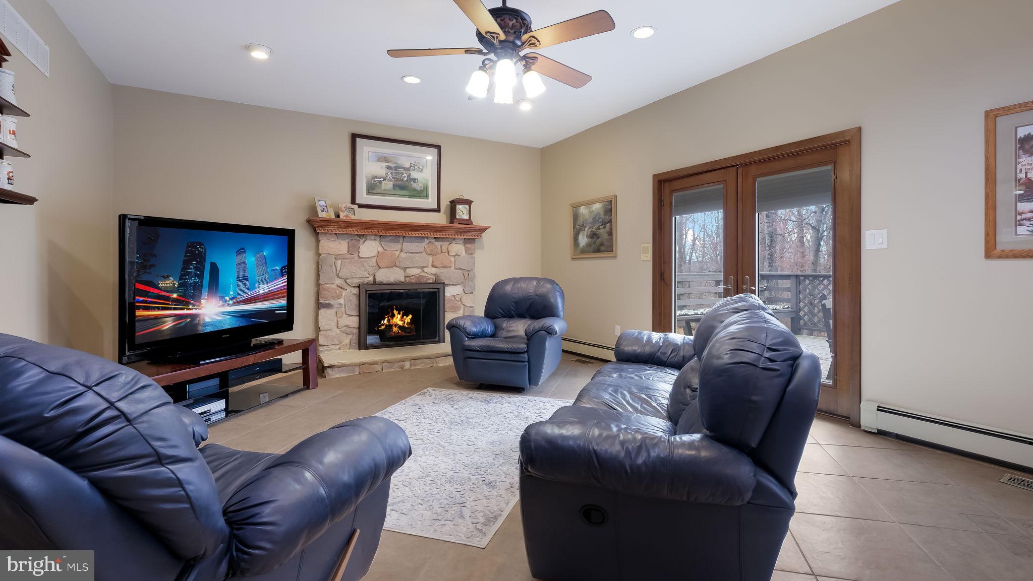 35 Declaration Drive Newtown, PA 18940 - Photo 9 of 53 a living room with furniture a flat screen tv and a fireplace
