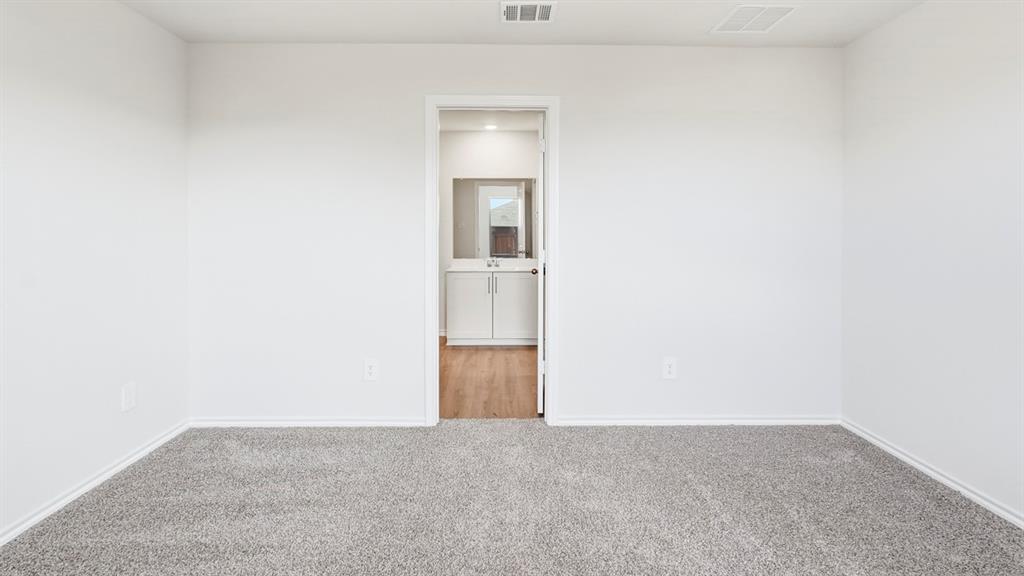 3319 Twilight Trail Forney, TX 75126 - Photo 17 of 33 Carpeted room with white walls and baseboards