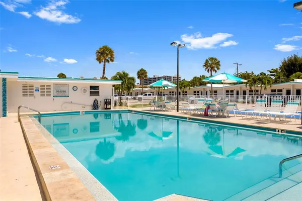 a view of a swimming pool with outdoor seating