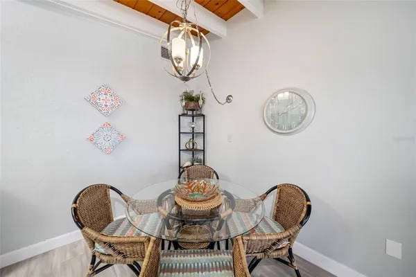 a kitchen with stainless steel appliances granite countertop a dining table and chairs with wooden floor