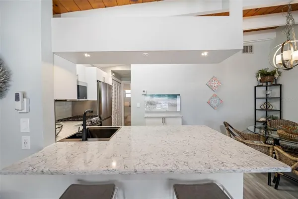 a view of a kitchen area with furniture and wooden floor