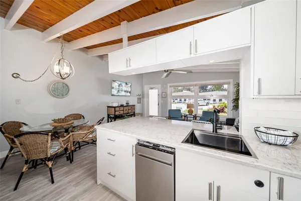 a kitchen with stainless steel appliances granite countertop a sink and a white cabinets