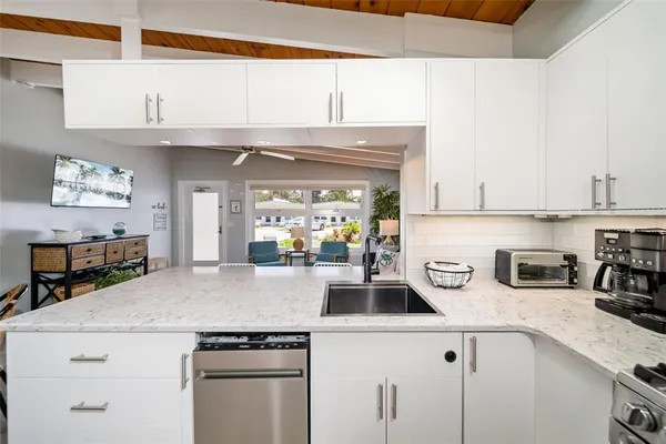 a kitchen with a sink a stove and cabinets