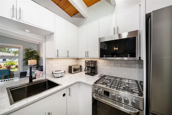 a kitchen with a refrigerator and a sink