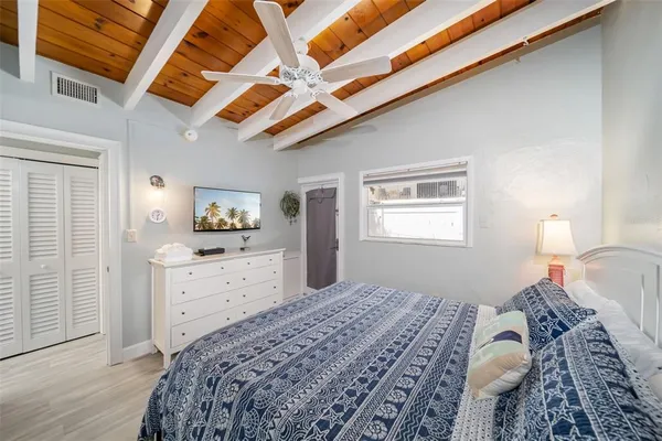 a bedroom with a large bed and a chandelier