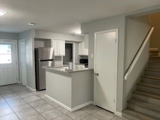 4226 Walnut Hills Drive, Unit 3 Corpus Christi, TX 78413 - Photo 4 of 11 a kitchen with stainless steel appliances granite countertop a refrigerator and a sink