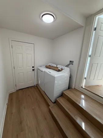 a view of a room with wooden floor