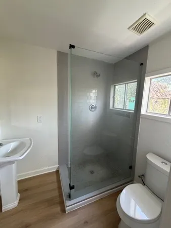 a white toilet sitting next to a bathroom sink