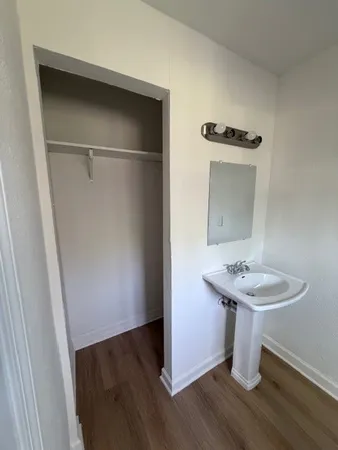 a bathroom with a sink toilet and mirror