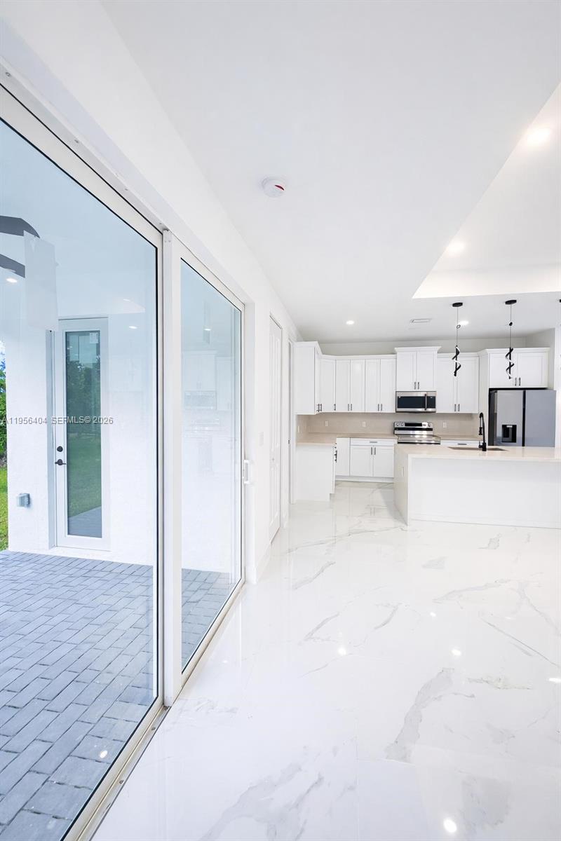 3901 East 19th Street Lehigh Acres, FL 33972 - Photo 6 of 11 a view of large kitchen with white cabinets