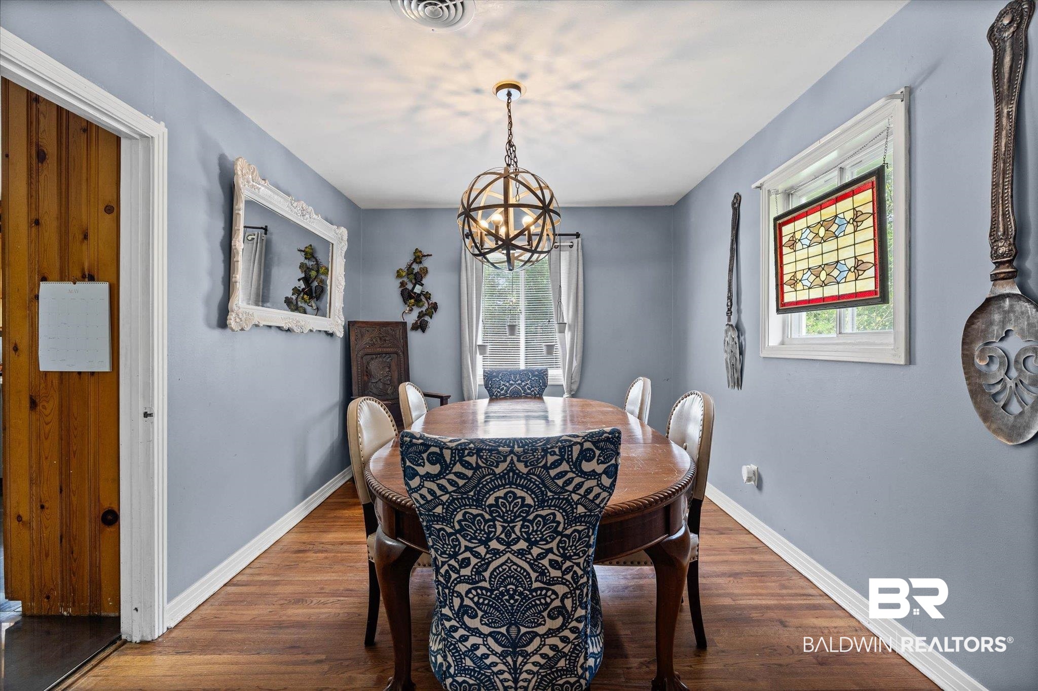 4213 Shan Drive East Mobile, AL 36693 - Photo 7 of 35 Formal dining area with wood-finish flooring, a contemporary chandelier, light blue wall paint, and white trim molding