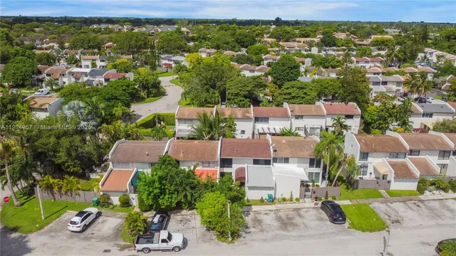 an aerial view of residential houses with outdoor space and street view