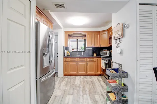 a kitchen with a refrigerator and a stove