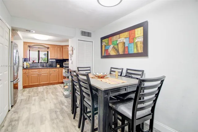 a view of a dining room with furniture and a kitchen