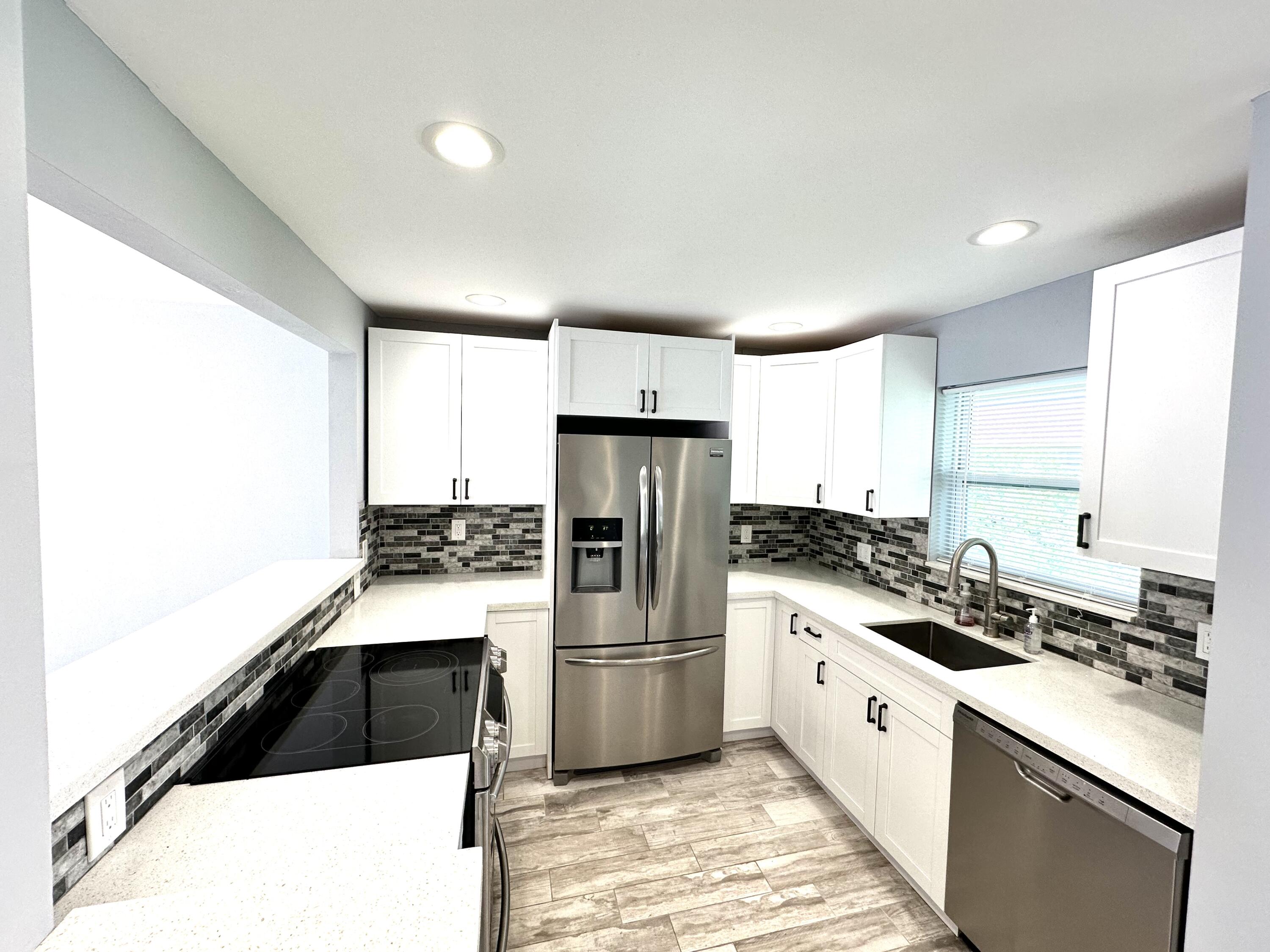 2162 Northeast 36th Street, Unit 46 Lighthouse Point, FL 33064 - Photo 1 of 15 a kitchen with a sink a stove and refrigerator