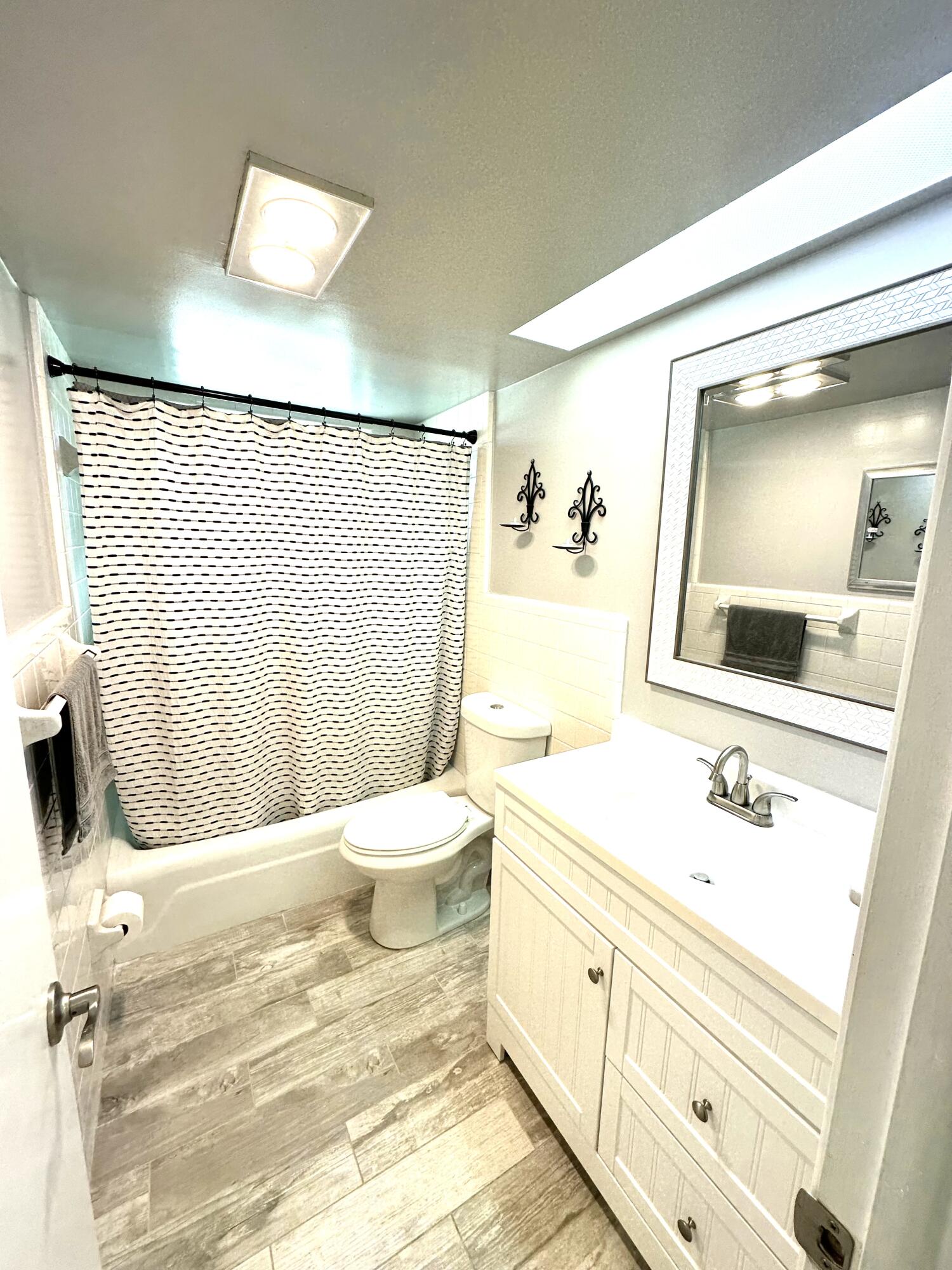 2162 Northeast 36th Street, Unit 46 Lighthouse Point, FL 33064 - Photo 11 of 15 a bathroom with a sink toilet and mirror