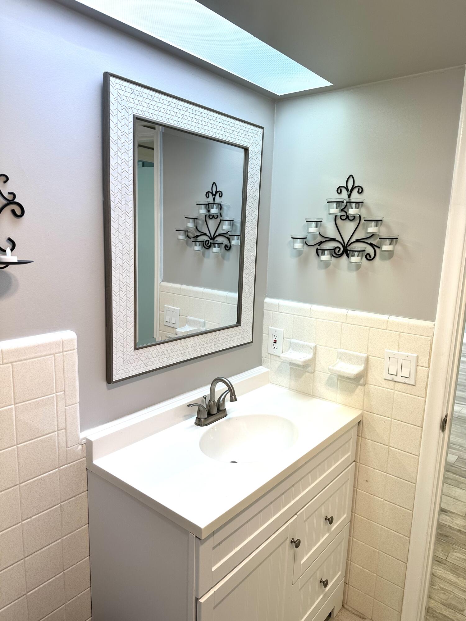 2162 Northeast 36th Street, Unit 46 Lighthouse Point, FL 33064 - Photo 12 of 15 a bathroom with a sink mirror and vanity