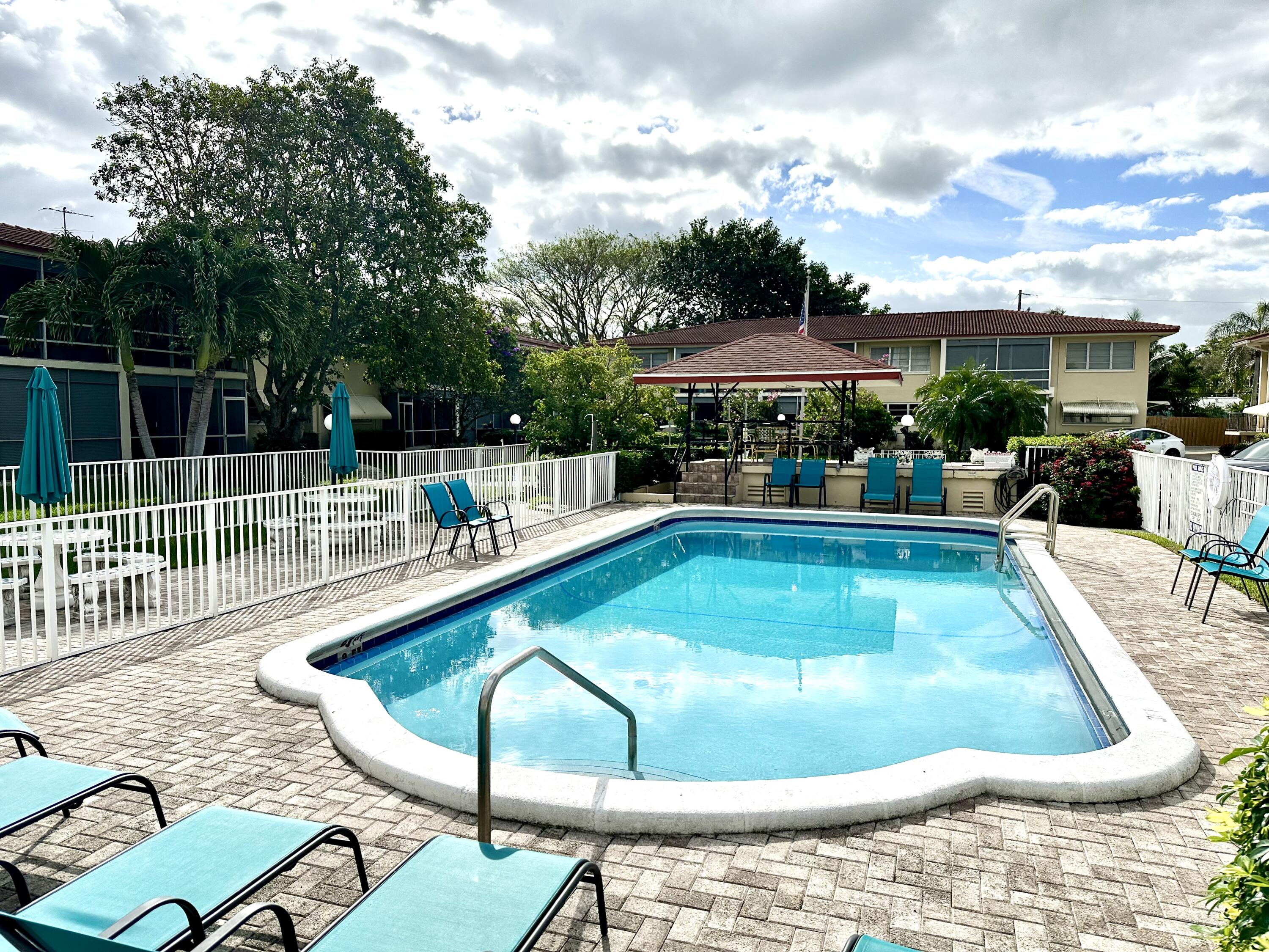2162 Northeast 36th Street, Unit 46 Lighthouse Point, FL 33064 - Photo 15 of 15 a view of a swimming pool with a patio
