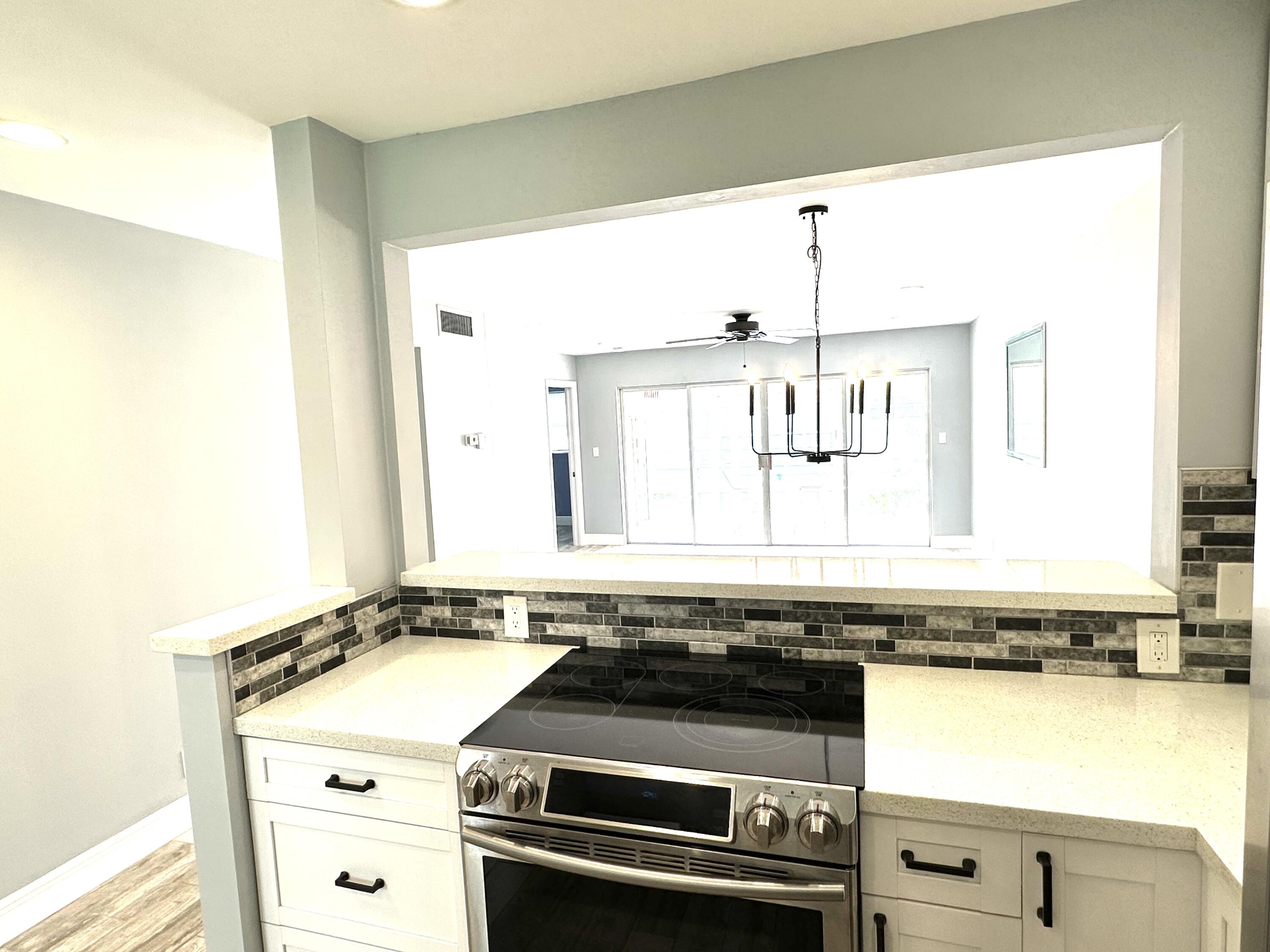 2162 Northeast 36th Street, Unit 46 Lighthouse Point, FL 33064 - Photo 2 of 15 a view of a kitchen with a sink and wooden floor