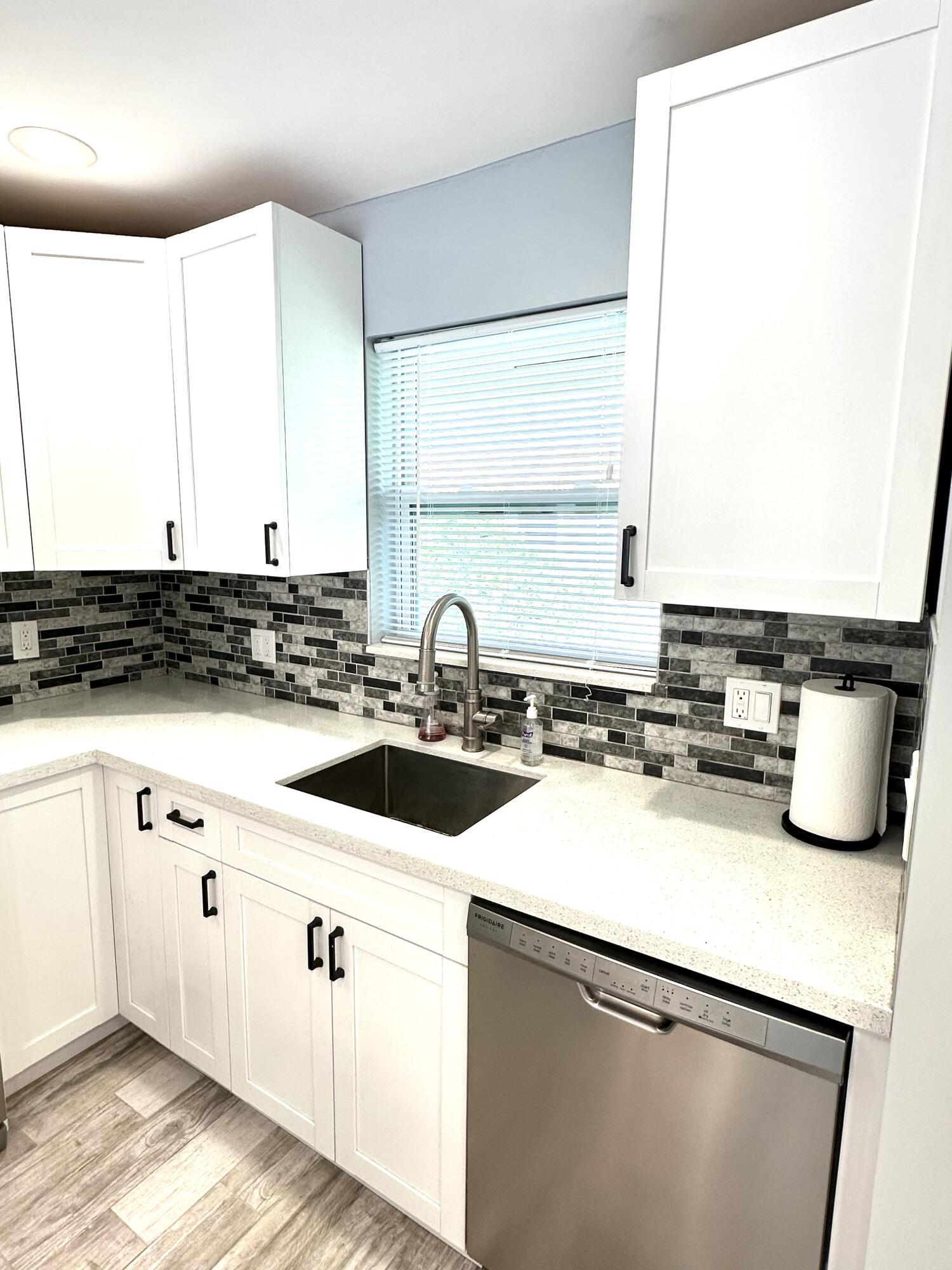 2162 Northeast 36th Street, Unit 46 Lighthouse Point, FL 33064 - Photo 3 of 15 a kitchen with a sink and a stove top oven