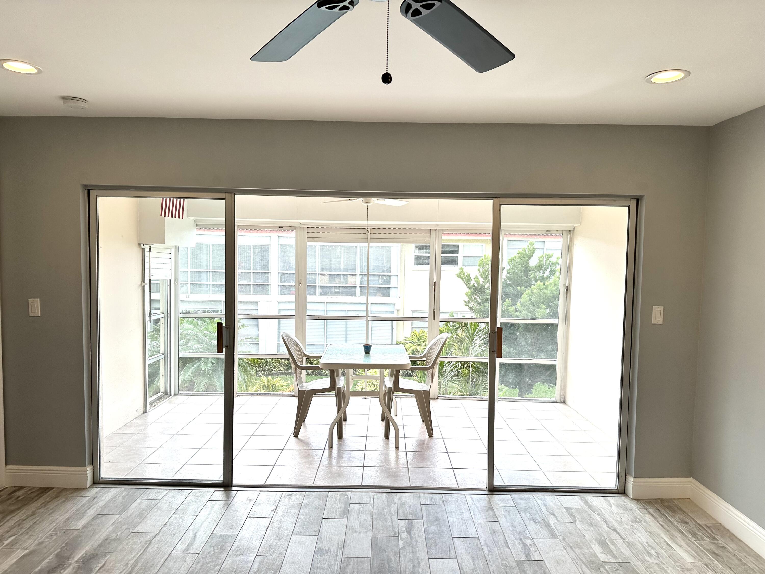 2162 Northeast 36th Street, Unit 46 Lighthouse Point, FL 33064 - Photo 6 of 15 a view of a room with wooden floor and windows